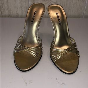 Bebe’s gold slip on strappy sandals